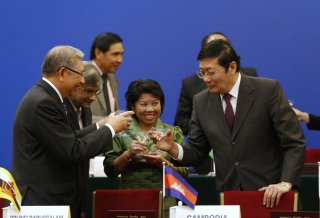 Chinese Finance Minister Lou Jiwei, right, toasts with friends through the signing service regarding the Asian Infrastructure Investment Bank at the Great Hall of th...